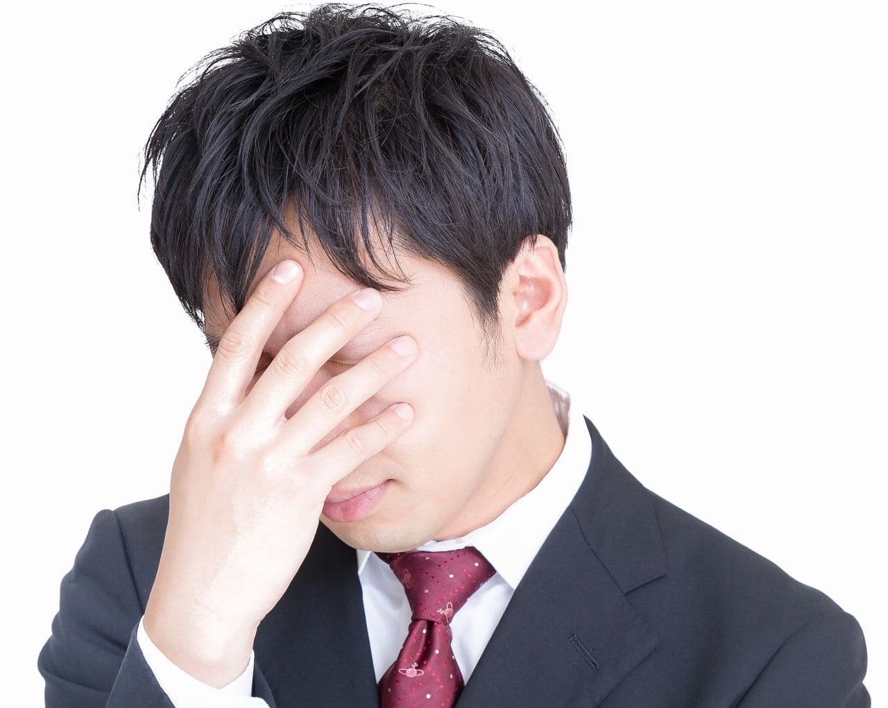 男性が頭を抱えている